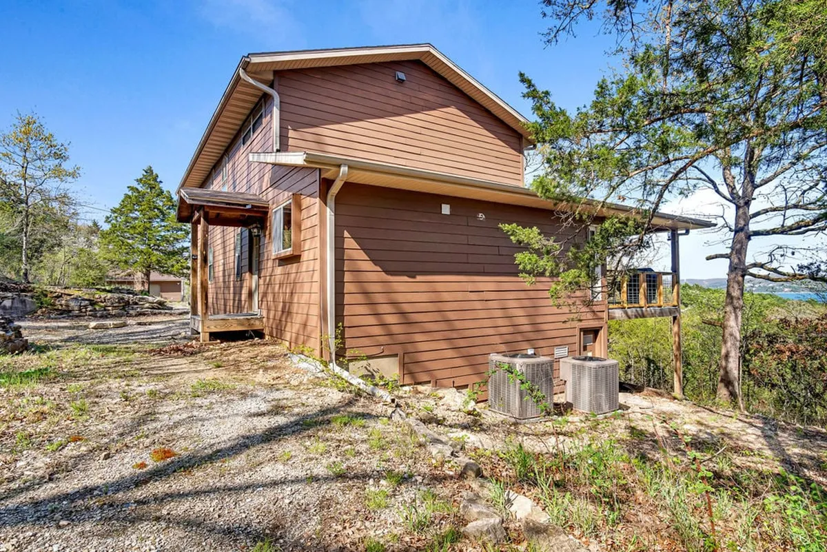 The wooden exterior of the home is surrounded by mature trees and features a spacious deck area, offering a seamless connection between indoor relaxation and outdoor exploration. The inviting setting echoes the retreat’s peaceful atmosphere.